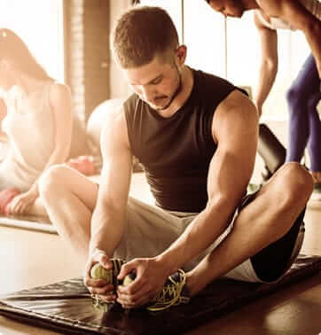 male athlete stretching before his workout