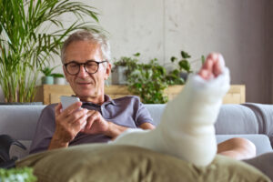 Senior man with broken leg at home