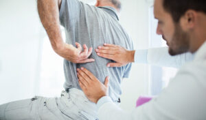 A senior Patient have medical exam for back pain with Orthopedic doctor