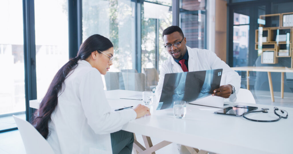 orthopedic surgeons discussing patient X-ray