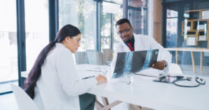 orthopedic surgeons discussing patient X-ray