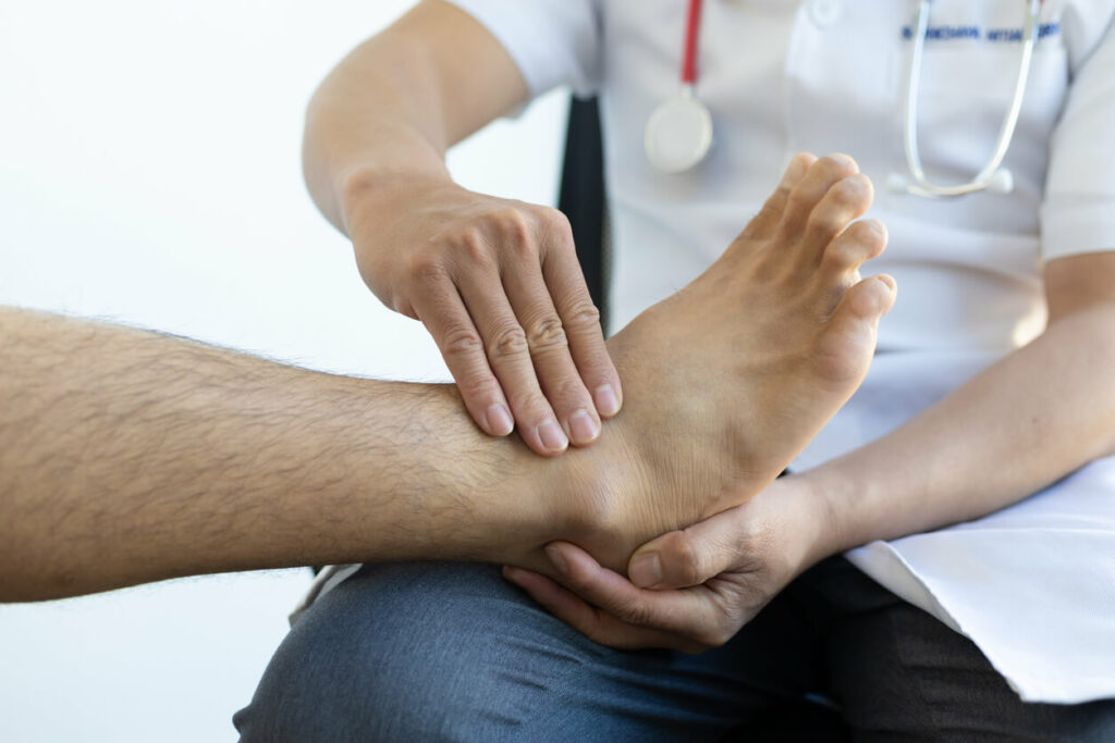 The doctor is diagnosing the foot pain of patient