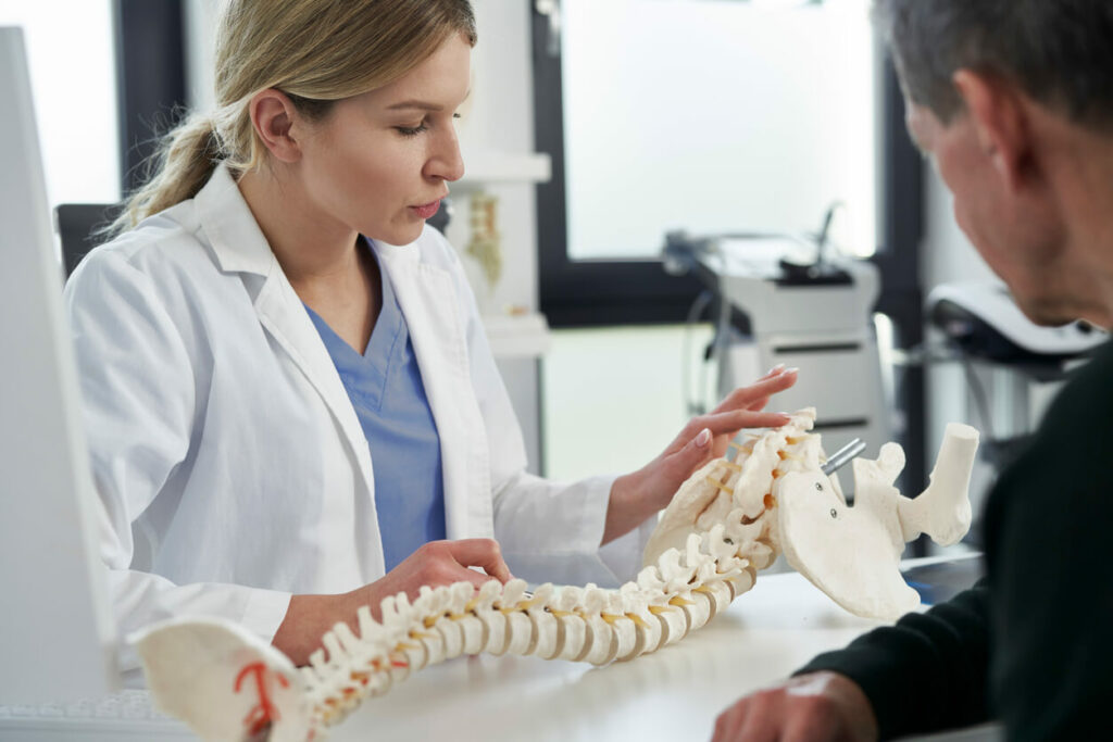 A Female Orthopedic Doctor Discussing With Patient At An Orthopedic Clinic.